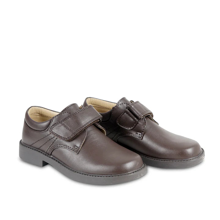 Pair of brown children's shoes with velcro straps on a white background